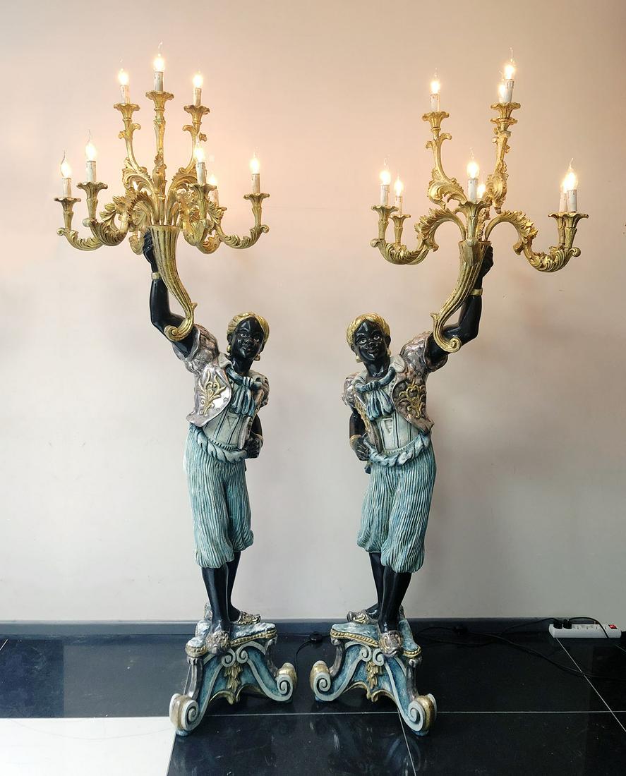 Set of 2 Wooden Black Servant Statues - Floor Lamps: A set of 2 wooden black servant statues - floor standing lamps. The statues feature intricate details and a beautiful paint job finished with silver and golden painted details. The chandelier style la