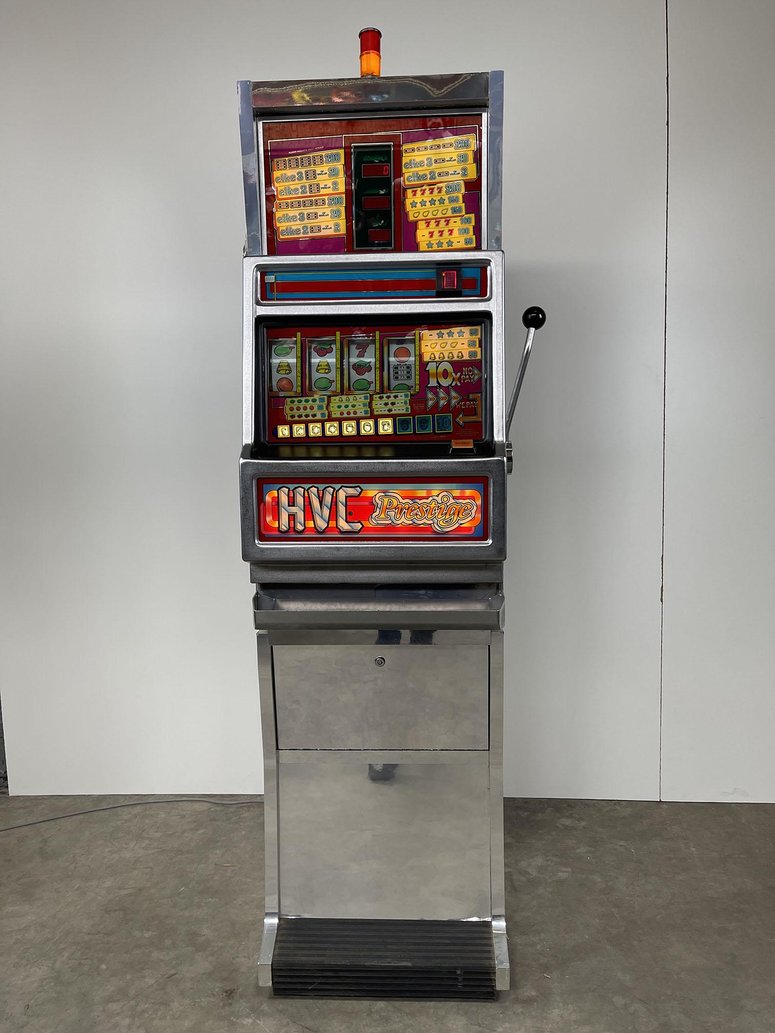 Dutch H.V.C. Prestige Slot Machine: Dutch H.V.C. Prestige slot machine, Amersfoort, Holland. Machine powers on, but the working condition hasn't been tested. Comes with keys. Height: 188 cm. Width: 52 cm. Depth: 53 cm. Condition: Very g