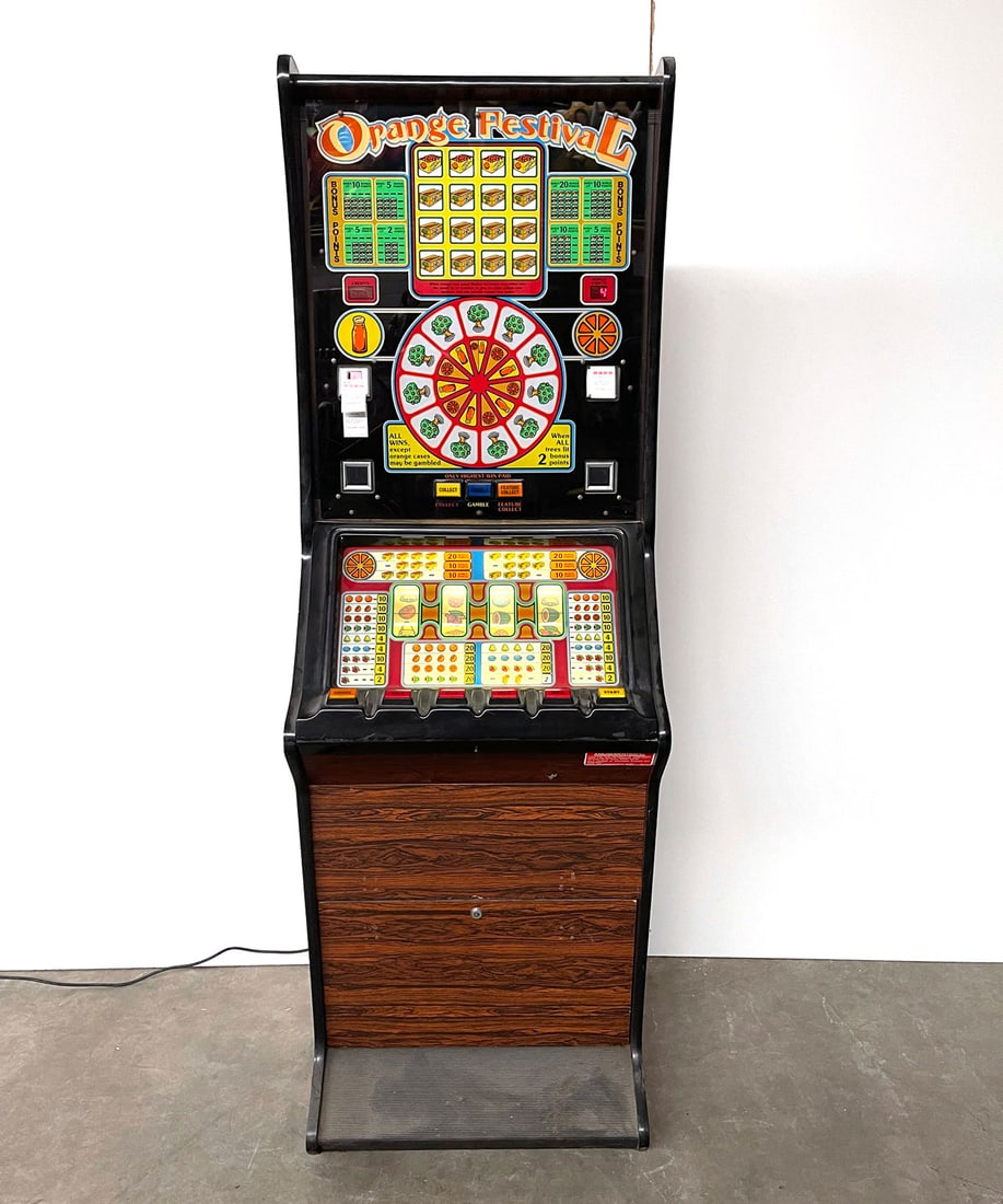 Dutch H.V.C. Orange Festival Slot Machine: Dutch H.V.C. "Orange Festival" slot machine. The labels on the slot machine are in English. Powers on, working condition untested. Height: 184 cm. Width: 60 cm. Depth: 57 cm. Condition: Good. Location