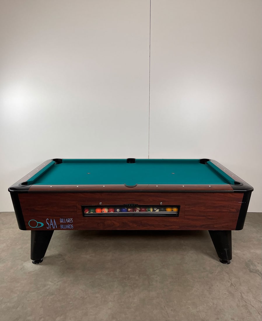 7ft SAM YOWA Coin-Op Billiards Table: 7ft SAM YOWA coin-op billiards table. The table comes with all the balls, 3 pool cues, cue holders, extra pool table cover, triangle rack and pool cue chalk. Shows regular signs of use. Height: 77 cm.