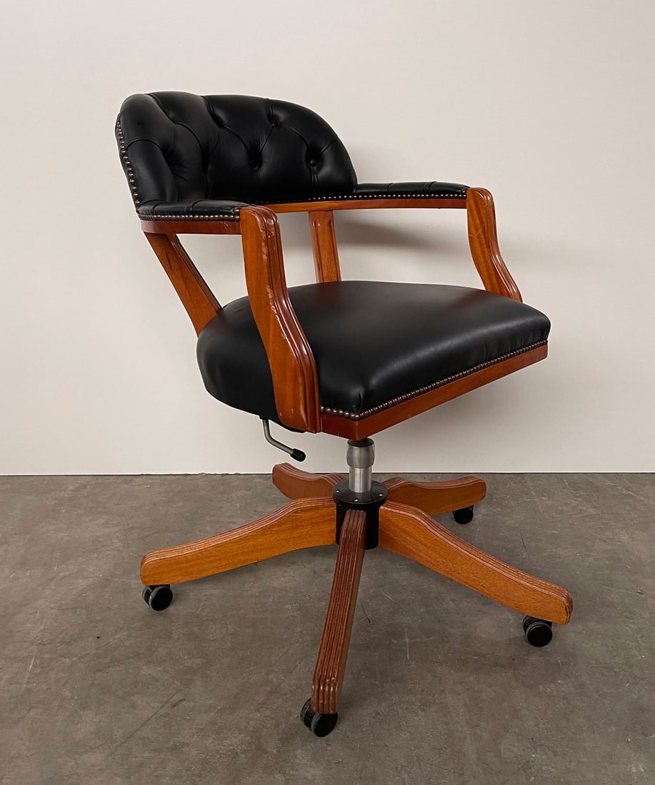 Chesterfield Style Office Chair Black Leather and Wood: Chesterfield style office chair made with stained polished wood and black leather. Shows signs of use, especially the wooden arms show scuffs. Height: 72 cm. Width: 51 cm. Depth: 85 cm. Condition: Goo