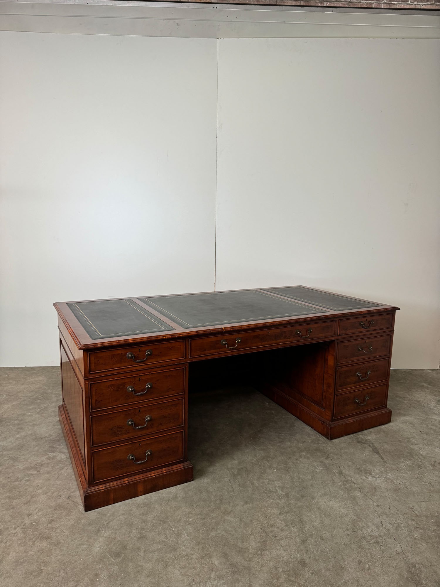 English Style Leather Top Pedestal Desk with File Drawers: English Style Leather Top Pedestal Desk with File Drawers. Comes with keys. Overall in a good, slightly worn condition. Dimensions (H x W x D): 80 x 202 x 101 cm. Condition: Good. Location: The Nether