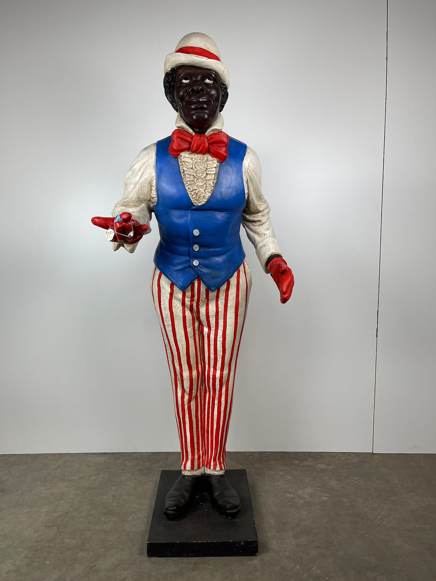 Lifesize Vintage Black Butler Plaster Statue: Lifesize vintage black butler plaster statue. Very nicely detailed with a nice paintwork, but right hand has a broken index finger that is currently attached to the hand by tape, minor color loss in o