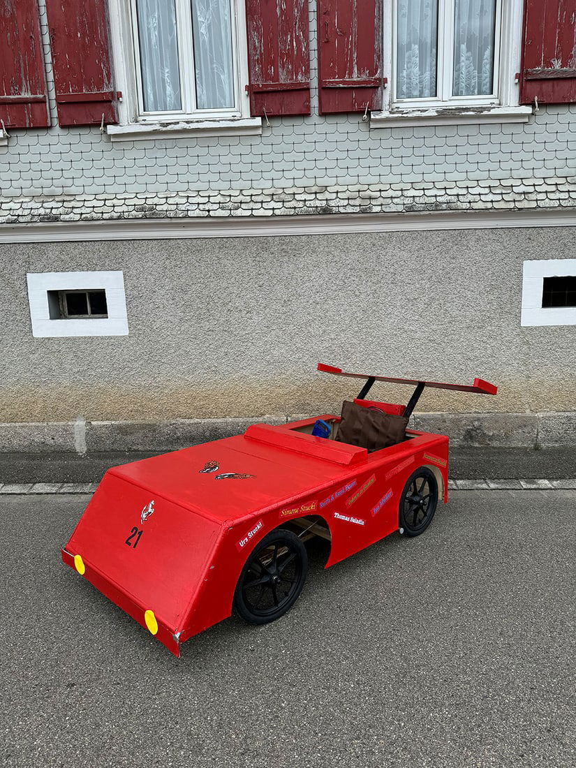 Charity Auction of "Ferrari" Gravity Racer/Soapbox: Gravity racer/soapbox car with a Ferrari theme sold in the auction with the proceeds going to charity. Charity initiator and designer/maker of the soapbox: C. Stucki, 15 years old. We warmly invite yo