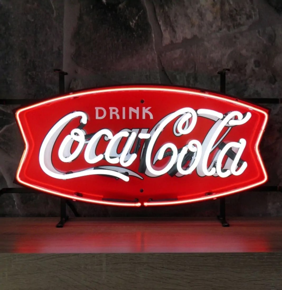 New Coca-Cola Fishtail Neon Sign with Backplate: Brand new Coca-Cola fishtail neon sign with backplate. Looks great both turned on and off. A great interior decoration. Dimensions (H x W x D): 35 x 62 x cm. Condition: New. Location: The Netherlands,