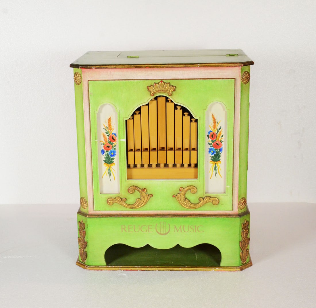 Beautiful Reuge Music "Monkey Organ": Beautiful Reuge Music "Monkey Organ" with 20 keys and 5 music rolls. Very good working and visual condition. Hand-painted wooden cabinet with elaborate floral decoration on green base. Price new was C