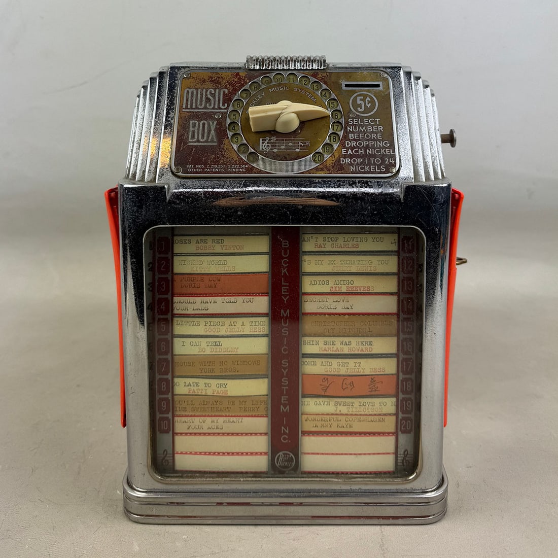 Buckley "Music Box" Wallbox 1939-1958: Buckley "Music Box" wallbox 1939-1958. Fair visual condition, shows wear and pitting to the chrome, name plate has lost all color, side plastics deformed and broken on one side. Comes with the keys. S