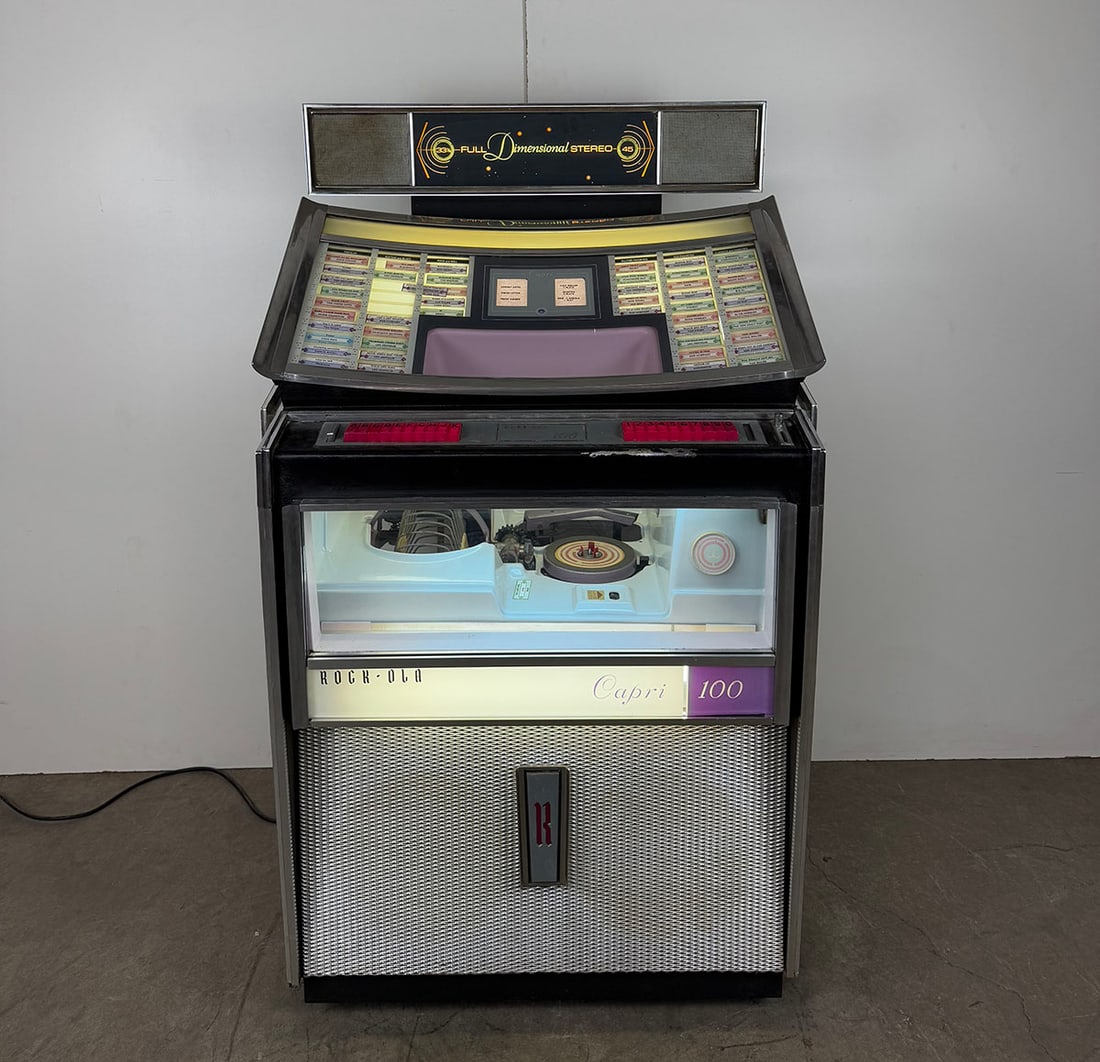 1963 Rock-Ola Model 404 Capri Jukebox with Speaker Kit: 1963 Rock-Ola Model 404 Capri jukebox with speaker kit. 100 selections of 45 RPM records. Visual condition: overall very good visual condition with nice chrome and refinished sides, shows some paint l