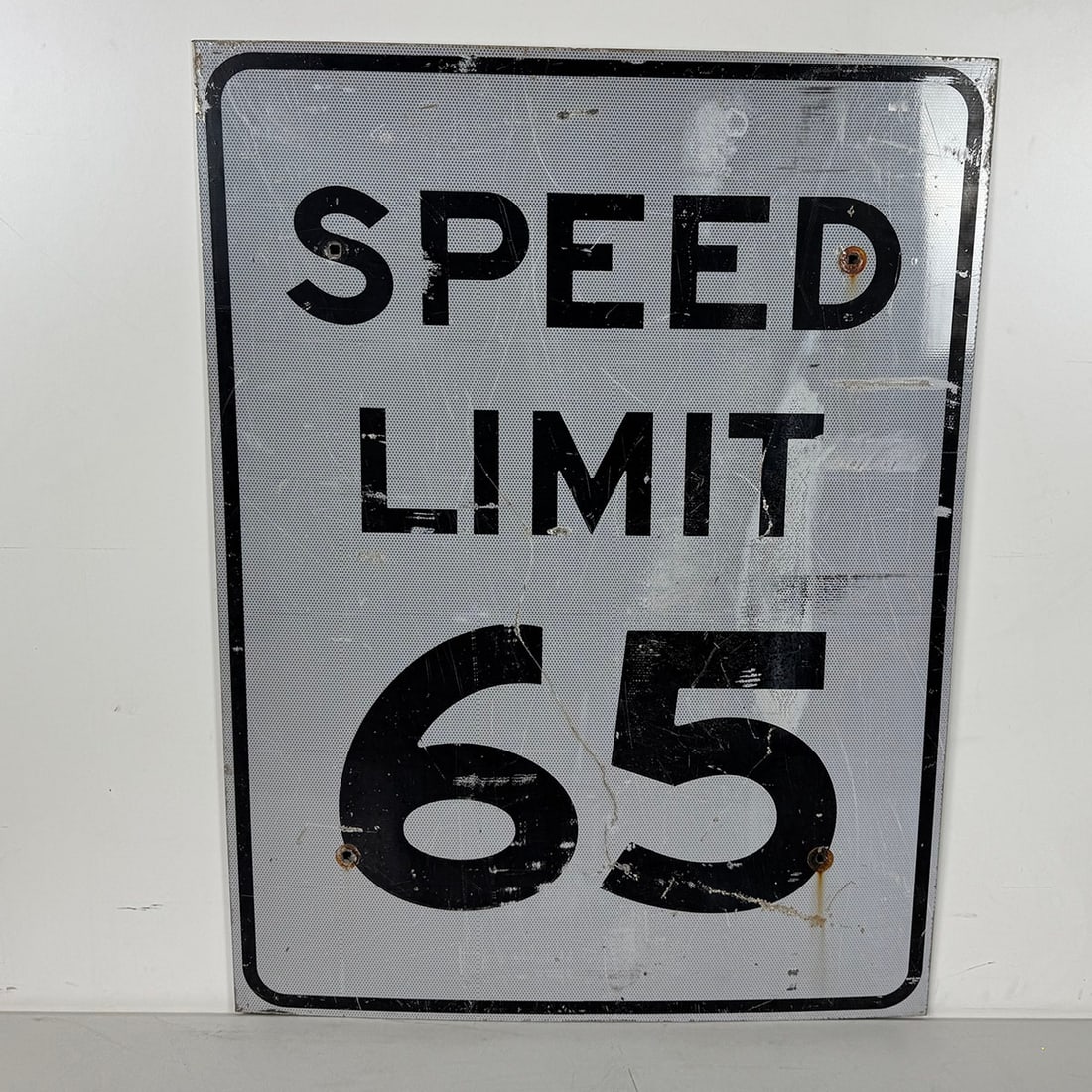 American Speed Limit 65 Traffic Sign: American Speed Limit 65 traffic sign. Fair visual condition showing moderate wear. Dimensions (H x W x D): 122 x 91 x 1 cm. Condition: Fair. Location: The Netherlands, Tilburg.