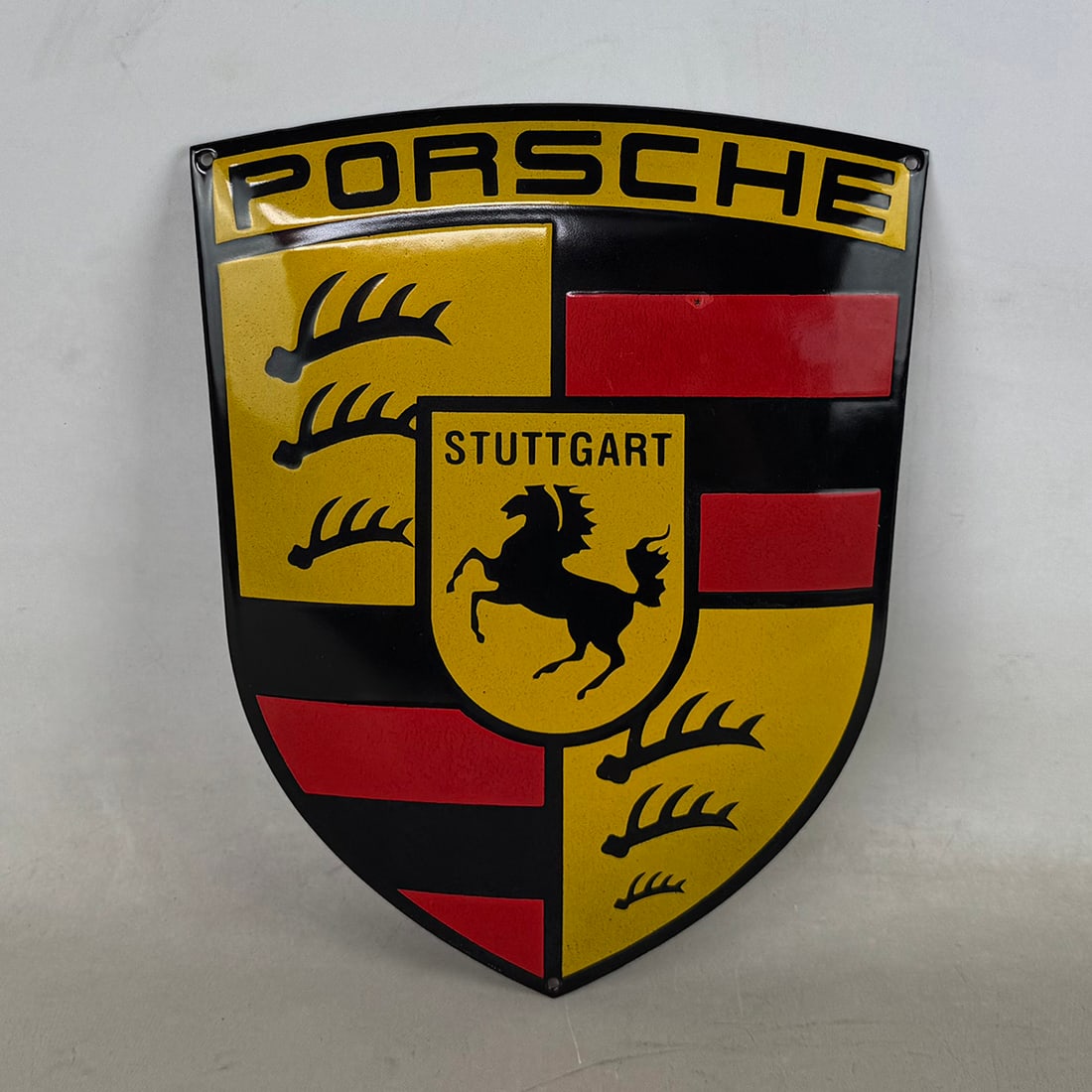 Porsche Logo Enamel Sign: Porsche logo enamel sign in excellent visual condition, showing minimal wear. Dimensions (H x W x D): 30 x 24 x 1 cm. Condition: Excellent. Location: The Netherlands, Tilburg.