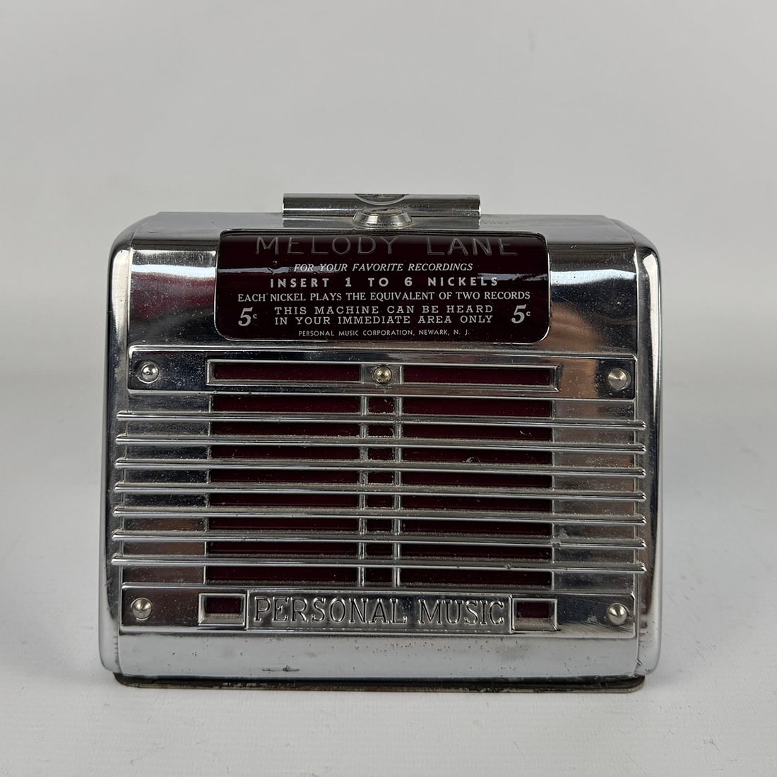 1945-1947 Personal Music Inc. Phonette Model F "Melody Lane" Non-Selective Wallbox : Personal Music Inc. Phonette Model F "Melody Lane" non-selective wallbox with a built-in speaker, 1945-1947. Very good visual condition, showing only light wear on the chromed metal case. Comes with k
