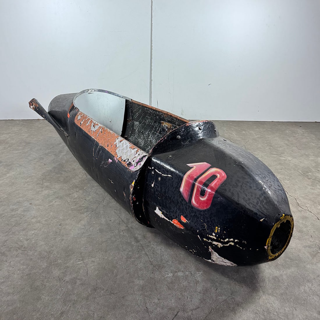 Fairground Ride Black Metal and Fiberglass Rocket No. 10: Black metal and fiberglass rocket No. 10 from an unknown fairground ride. The rocket is in fair, unrestored condition. Dimensions (H x W x D): 65 x 233 x 70 cm. Condition: Fair. Location: The Netherla