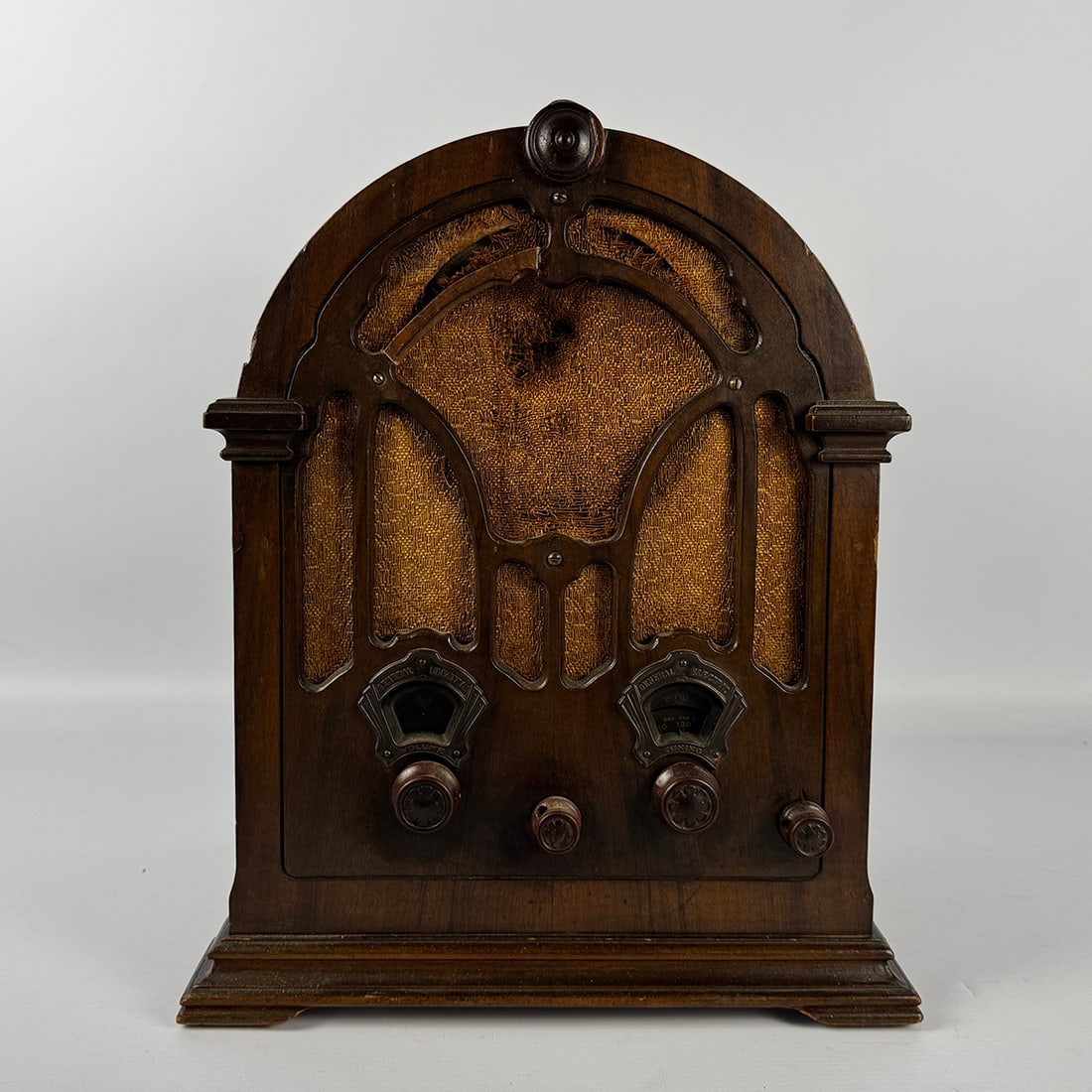 General Electric K-63 Six Tube Radio (1933): General Electric K-63 (1933) six-tube two-band (AM, police) radio. The wooden cathedral cabinet is almost fully original, only the back panel has been reproduced. The radio has the original knobs, cha