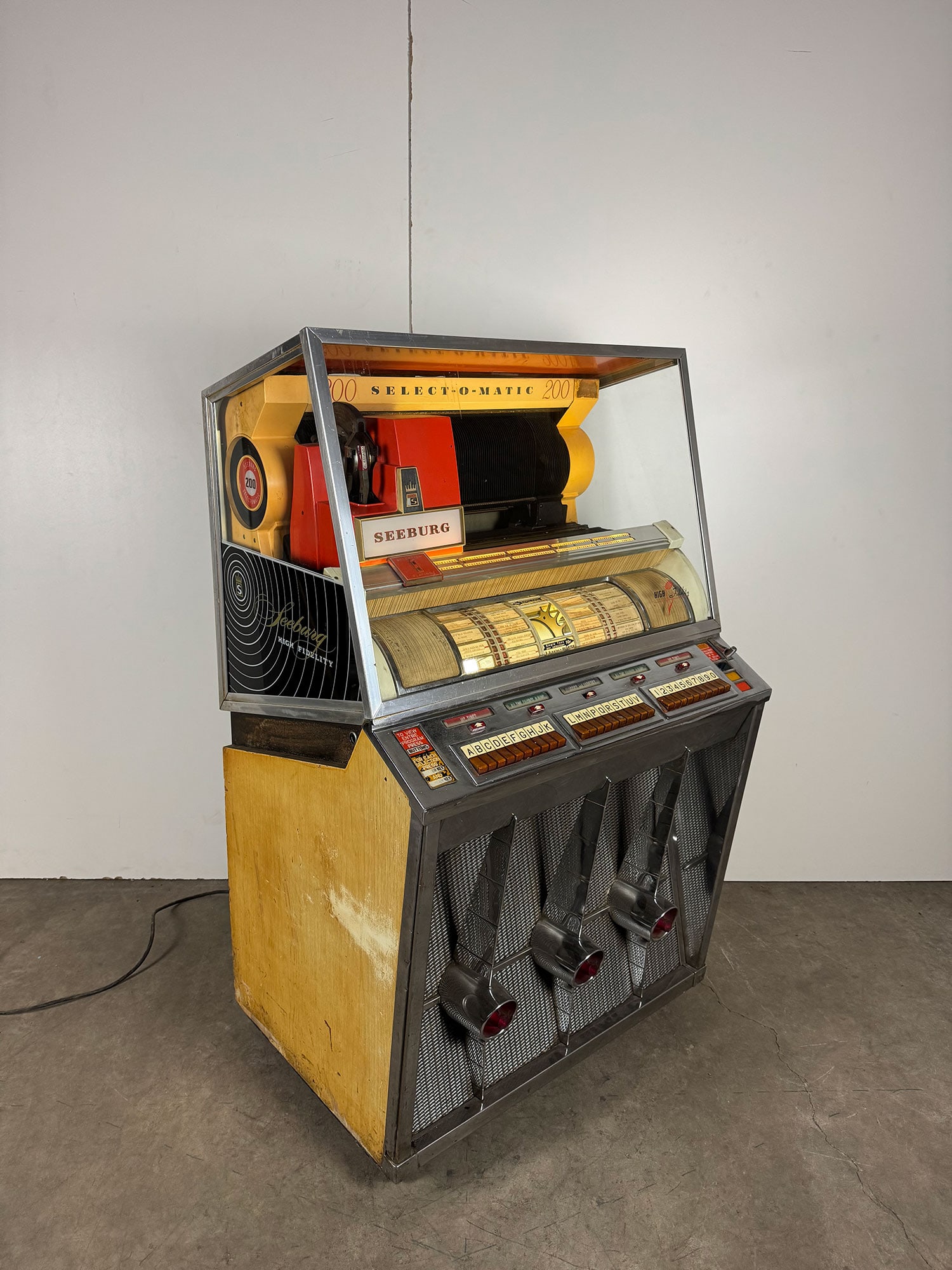 Seeburg Model KD-200 Jukebox (1957): 1957 Seeburg KD-200 jukebox. 200 selections of 45 RPM records. Visual condition: good original visual condition, the metal case and bleached walnut side panels show some wear, some pitting on the chro