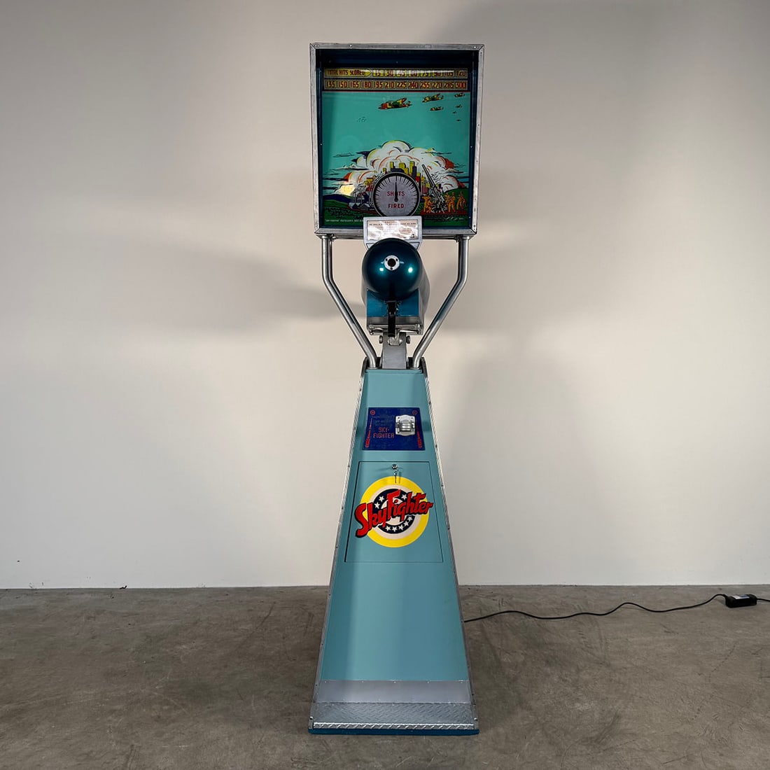 Sky Fighter International Mutoscope Corp. Shooting Arcade Game (ca. 1940): International Mutoscope manufactured this WWII themed "Sky Fighter" game in 1940. The tall cabinet is constructed of wood and shows an recent restoration, complete with the original instructions paper