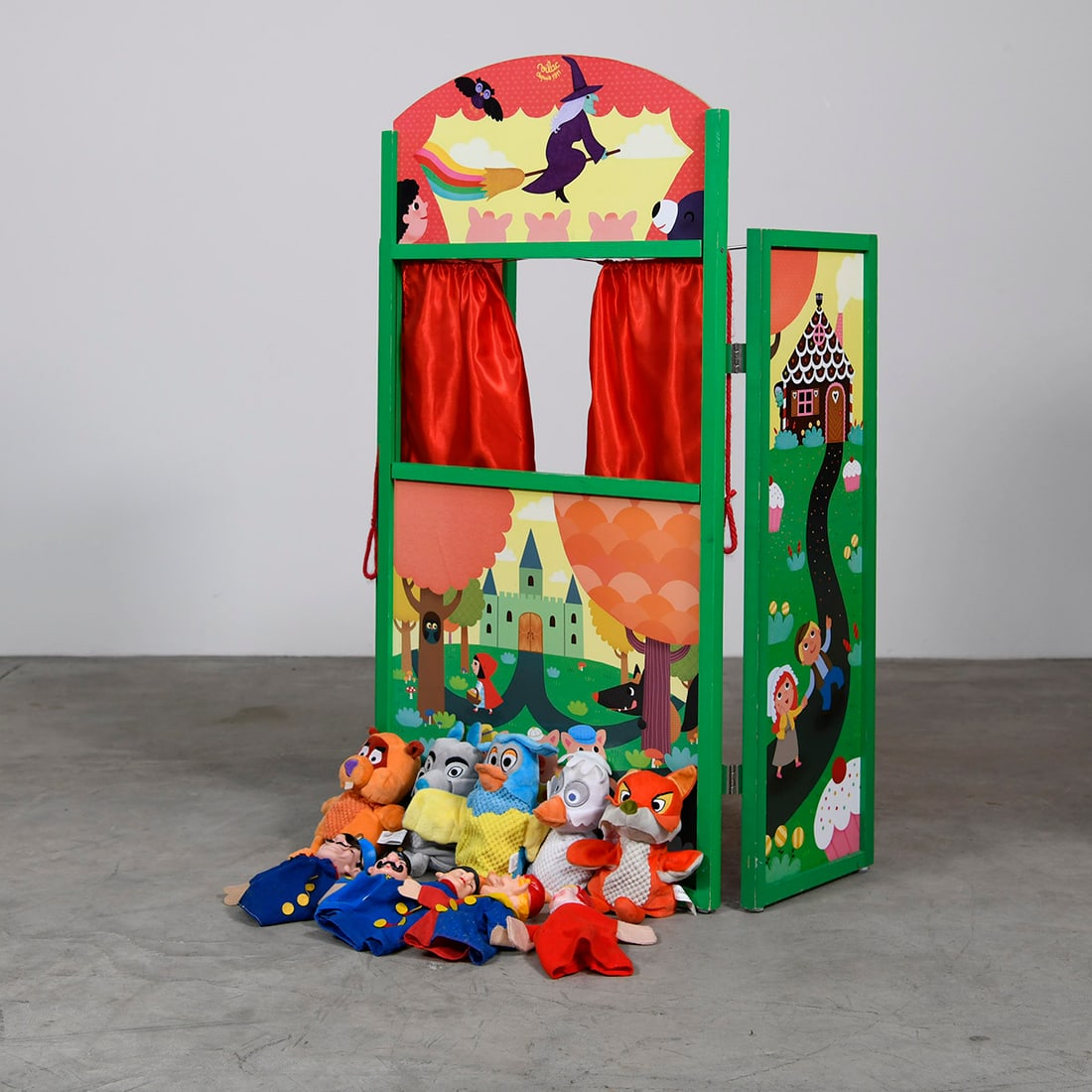 Small Portable Wooden Puppet Theater with 10 Hand Puppets: This small wooden puppet theater features vibrant artwork and integrated red fabric curtains. It comes with a collection of 10 hand puppets. The theater is designed for portable performances with the