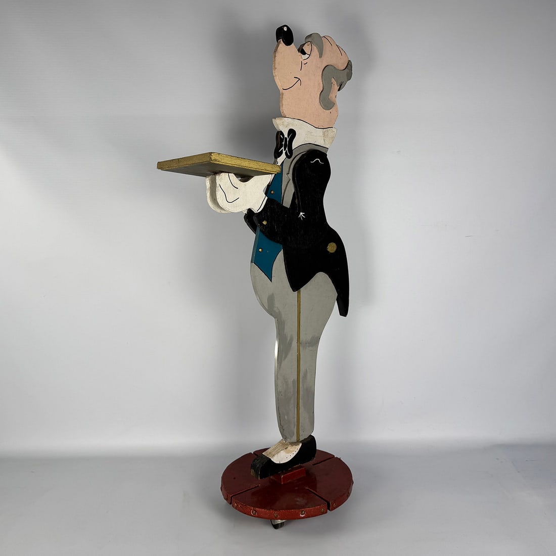 Vintage Wooden Hand-painted Butler Figure Inspired by the Disney "Duckworth" Character: Vintage wooden hand-painted butler figure, inspired by the Disney "Duckworth" character. The figure is mounted on a wooden base with wheels and holds a small wooden tray designed for holding lightweig
