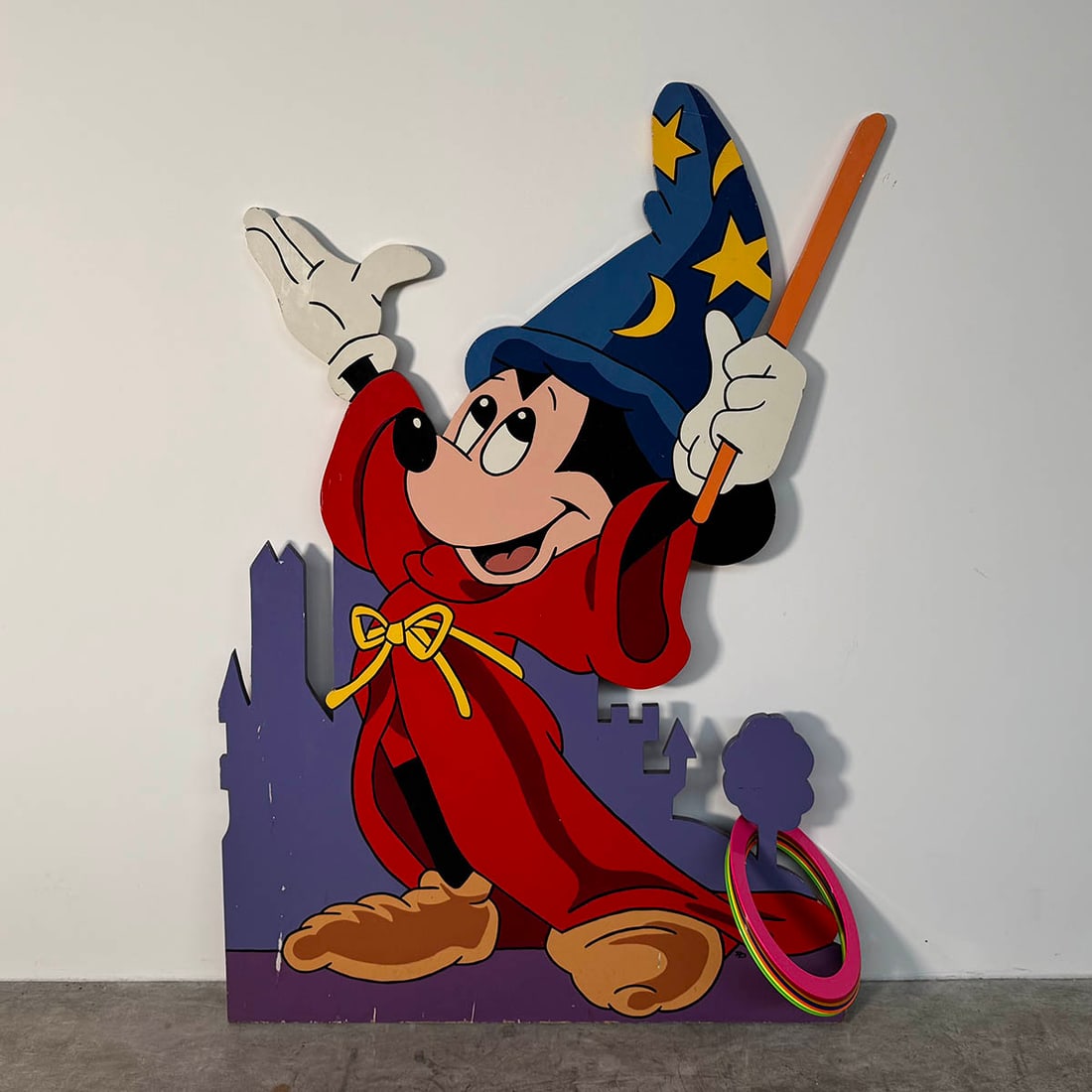 Double-sided Wooden Cutout Disney's Fantasia Sorcerer Mickey Ring Toss Game with 7 Plastic Rings: Double-sided wooden cutout ring toss game with 7 plastic rings featuring Sorcerer Mickey from Disney's Fantasia. Very good visual condition, showing some wear. Dimensions (H x W x D): 161 x 110 x 2 cm