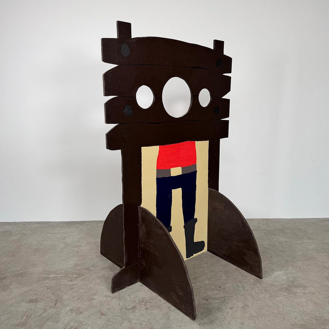 Vintage Wooden Pillory Carnival-style Photo Prop in "Old West" Style: This vintage wooden pillory is a classic carnival-style photo prop designed in a playful "Old West" aesthetic. It features two thick, horizontal wooden beams with three circular cutouts - one large ce