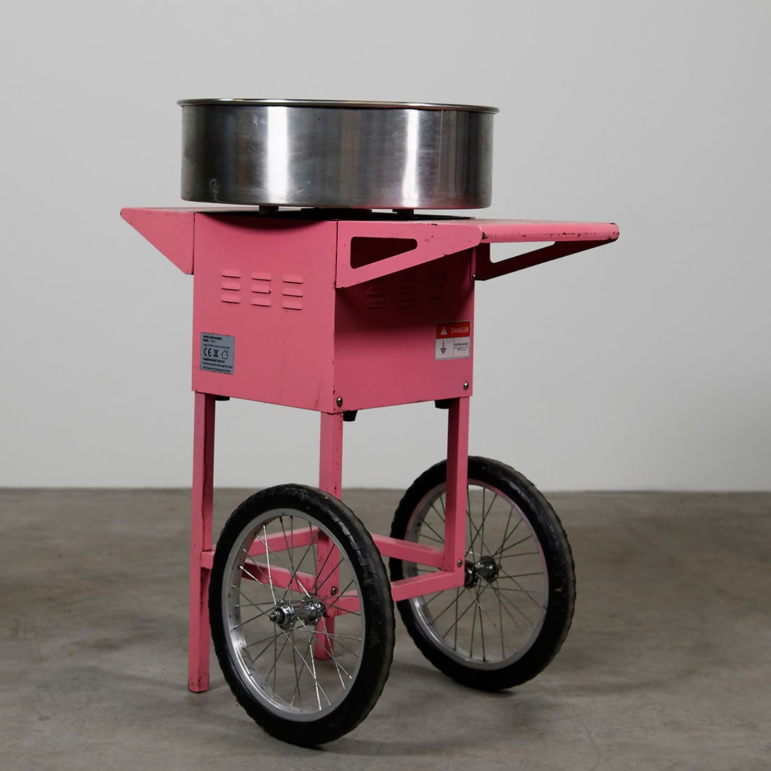 Pink Cotton Candy Machine 1300W Model CCM-01 with Wheels: Pink cotton candy machine 1300W model CCM-01 with stainless steel bowl and wheels. Good used visual condition and good working good condition on 230V power. Dimensions (H x W x D): 96 x 50 x 80 cm. Co