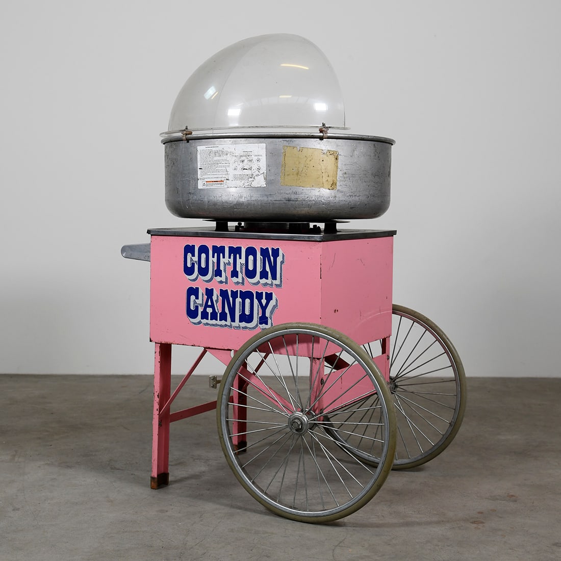 Gold Medal Econo Floss Cotton Candy Machine with Cart: Econo Floss cotton candy machine by Gold Medal including cotton candy cart with large wheels. Cotton candy machine with heat control thermostat and aluminium bowl with half wind hood. Good visual and