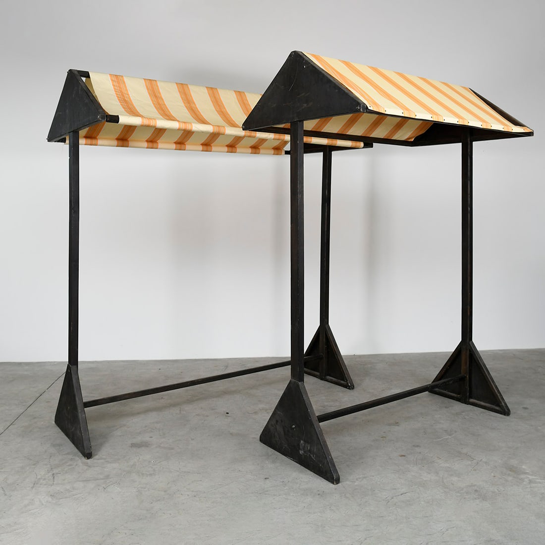 Set of 2 Wooden Market Stands with Yellow and White Striped Canopy: This pair of matching wooden market stands features a classic, rustic design topped with vibrant yellow and white striped canvas canopies. These stands are modular and easily transportable, making the