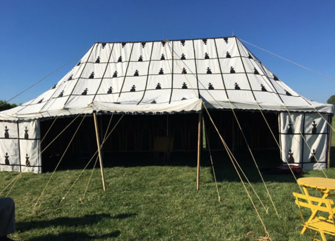 Complete White Arabian-style Tent with Black Emblems: This White Arabian-style tent features a traditional pointed canopy accented with black emblems. This set includes the main canopy along with all necessary supporting poles and stainless steel upright