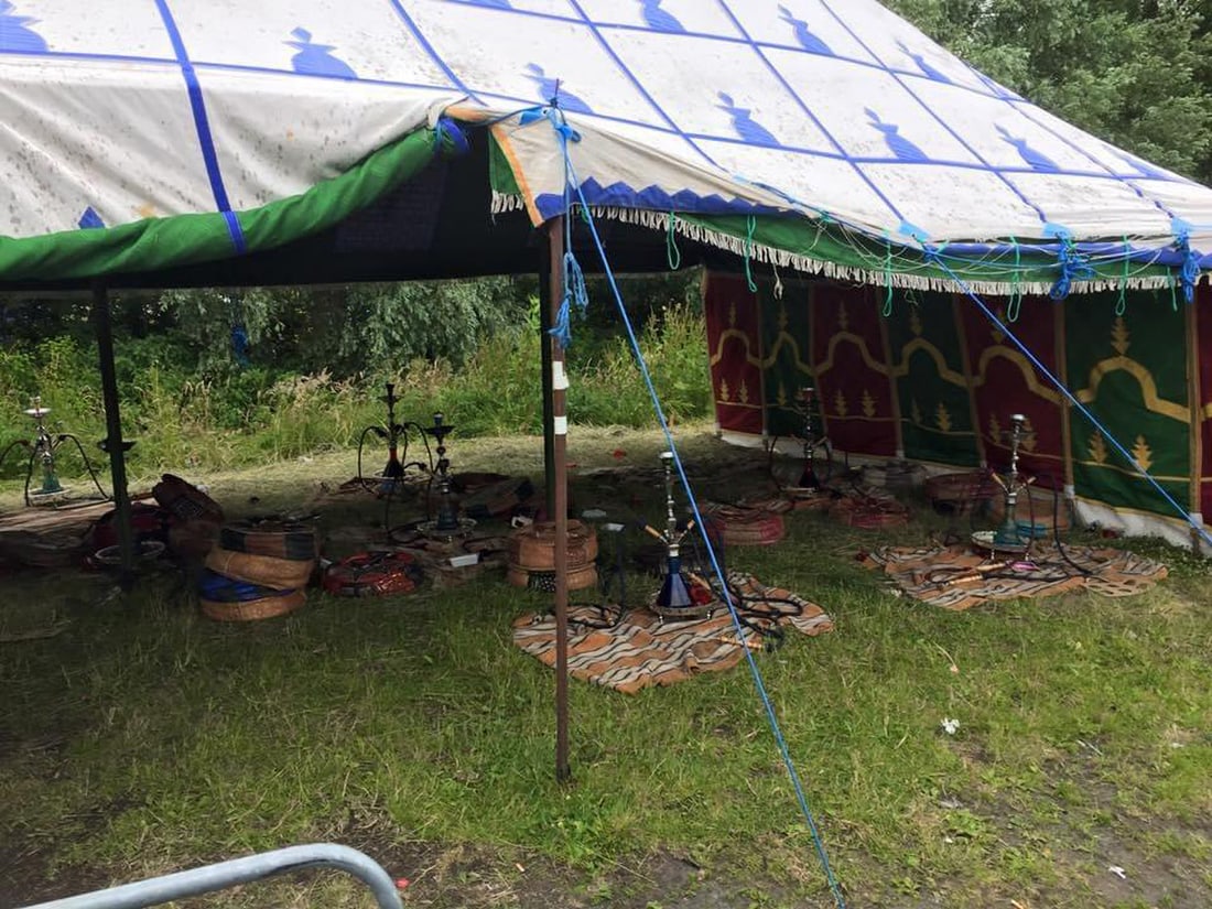 White Arabian-style Tent with Blue Emblems with 7 Rolls of Side Walls without Tent Poles: White Arabian-style tent with blue emblems. The tent is sold as is with 7 rolls of side walls, but without the tent poles. Approx. dimensions for the tent are: 10 meters wide by 6 meters deep. With co