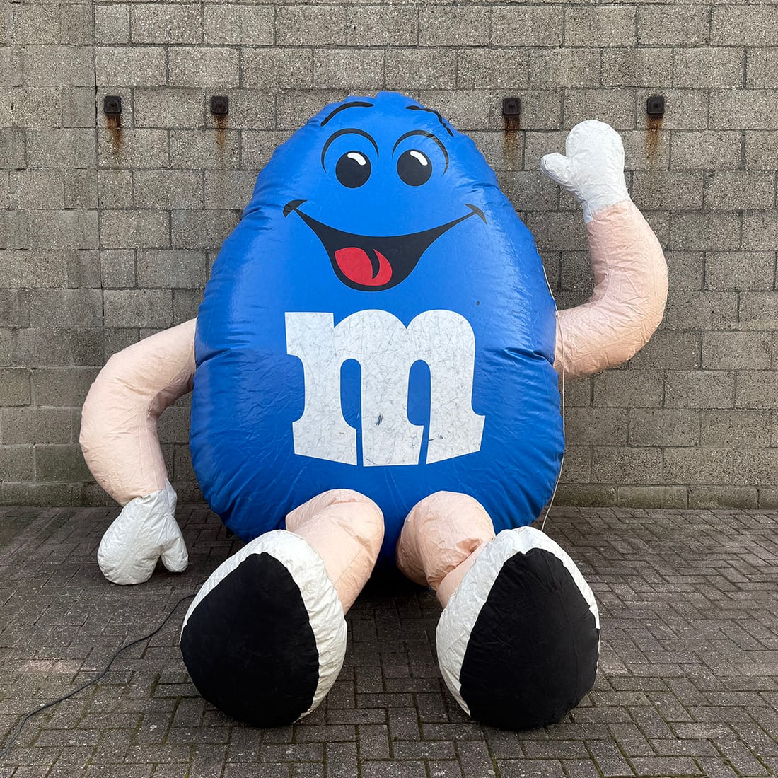Large inflatable Blue M&M Character Promotional Unit: Large inflatable Blue M&M character promotional unit. Constructed from durable, weather-resistant PVC, the figure includes internal structural supports and a integrated air-intake system protected by