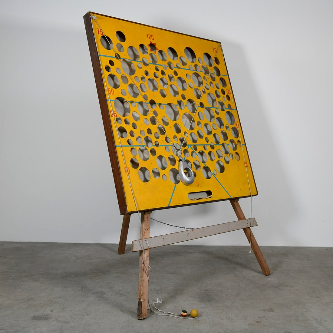 Vintage Wooden Fairground Skill Game "The Cheese Game": This vintage wooden skill game, often known as "The Cheese Game", consists of a large, yellow-painted upright board perforated with holes of varying sizes and point values ranging from 10 to 100. It i