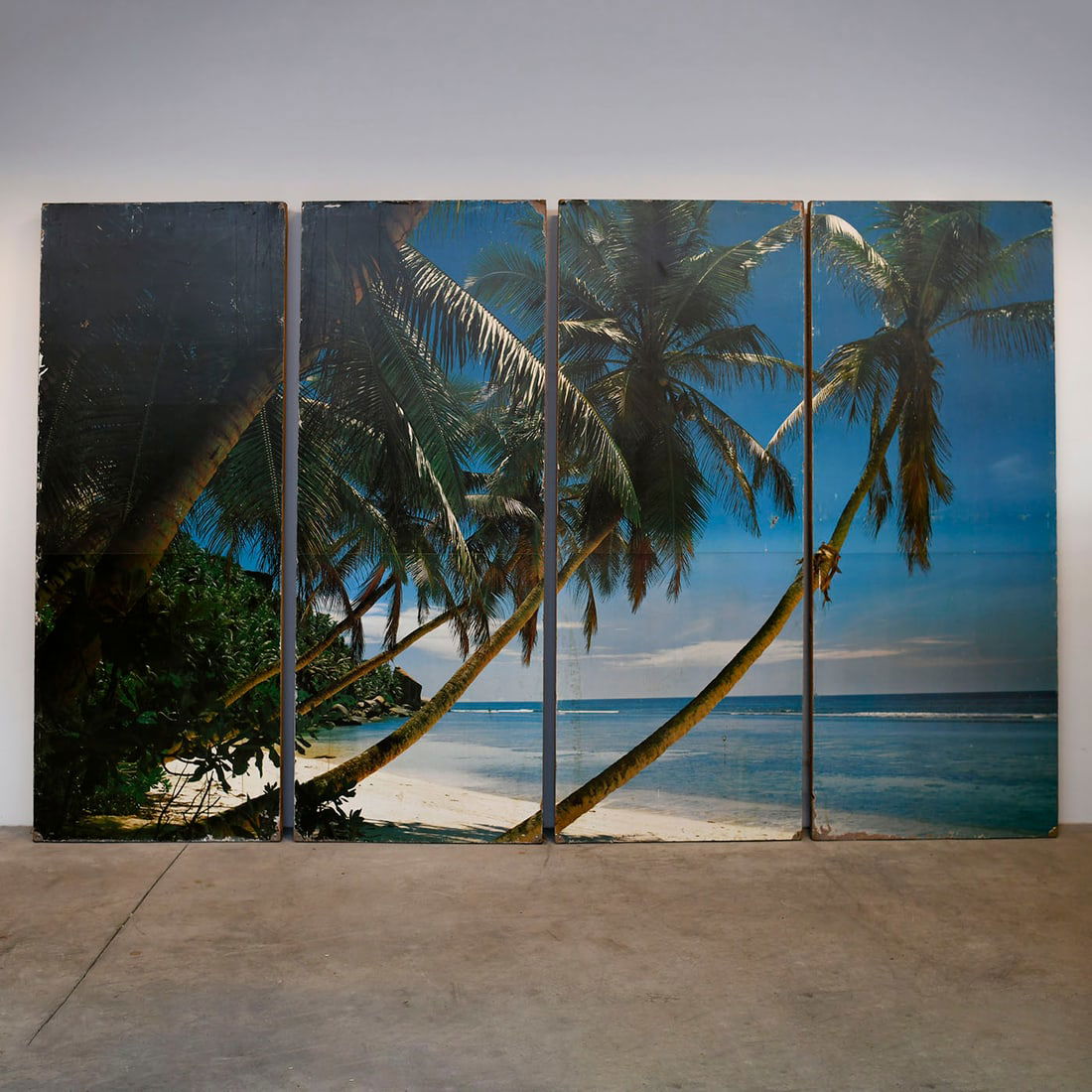 4 Palm Beach panels: Set of four large decorative panels depicting a tropical beach scene with palm trees and ocean view. Likely used as stage or decorative backdrop panels. Condition: Used with visible signs of wear cons