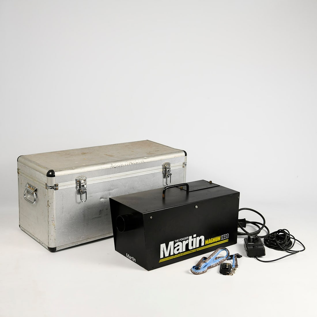Martin Magnum 1600 Smoke Machine with Metal Case and Smoke Fluid: Martin Magnum 1600 smoke machine supplied with a metal transport/storage case. The lot also includes approximately one and a half containers of smoke fluid. Functionality not tested. Good used visual