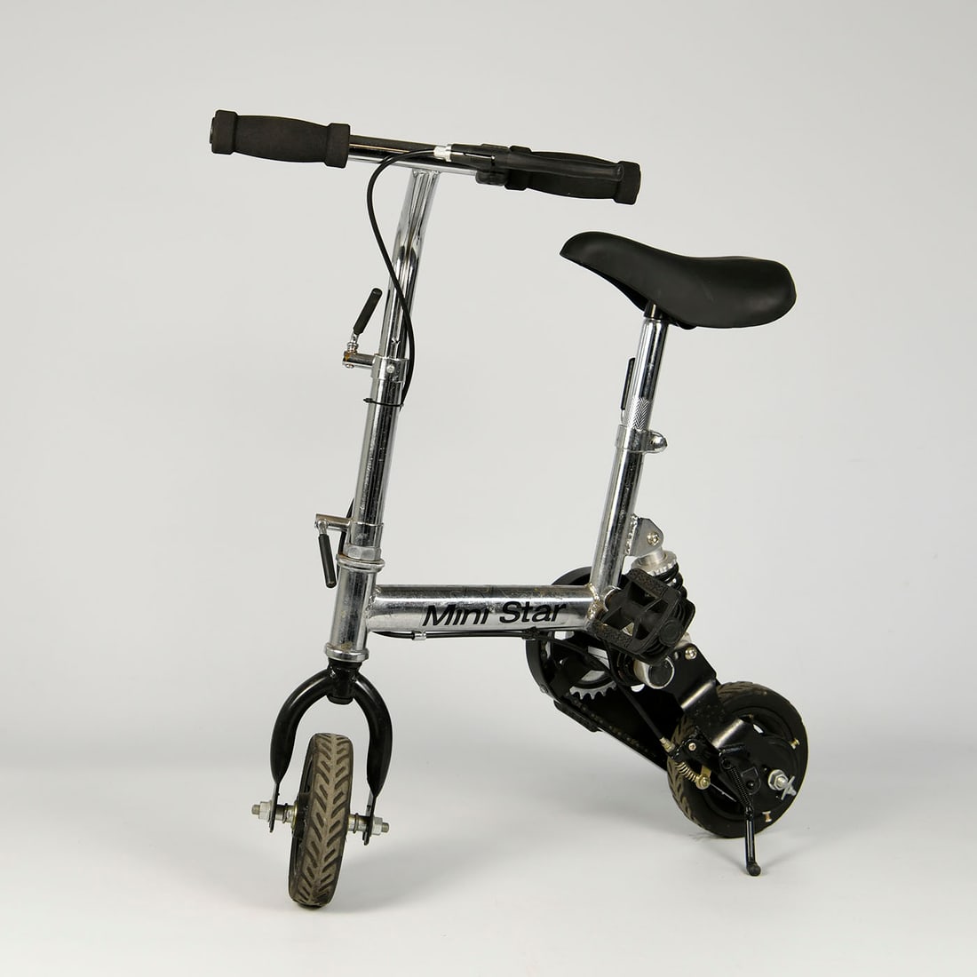 Mini clownsfiets chroom: Small chrome mini clown bicycle with compact frame, small wheels, and adjustable saddle and handlebars. A novelty bicycle often used for circus acts, performances, or as a decorative collectible. Cond