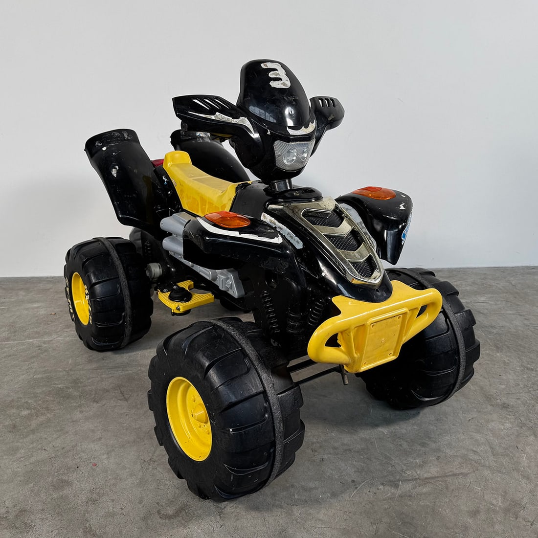 Electric Kids Quad Bike - Fully Working Condition Black and yellow ( this one has a charger): Electric children’s quad bike in a sporty black and yellow color scheme. The quad features large plastic wheels with rugged tread, a molded seat, handlebars, and decorative engine details that give