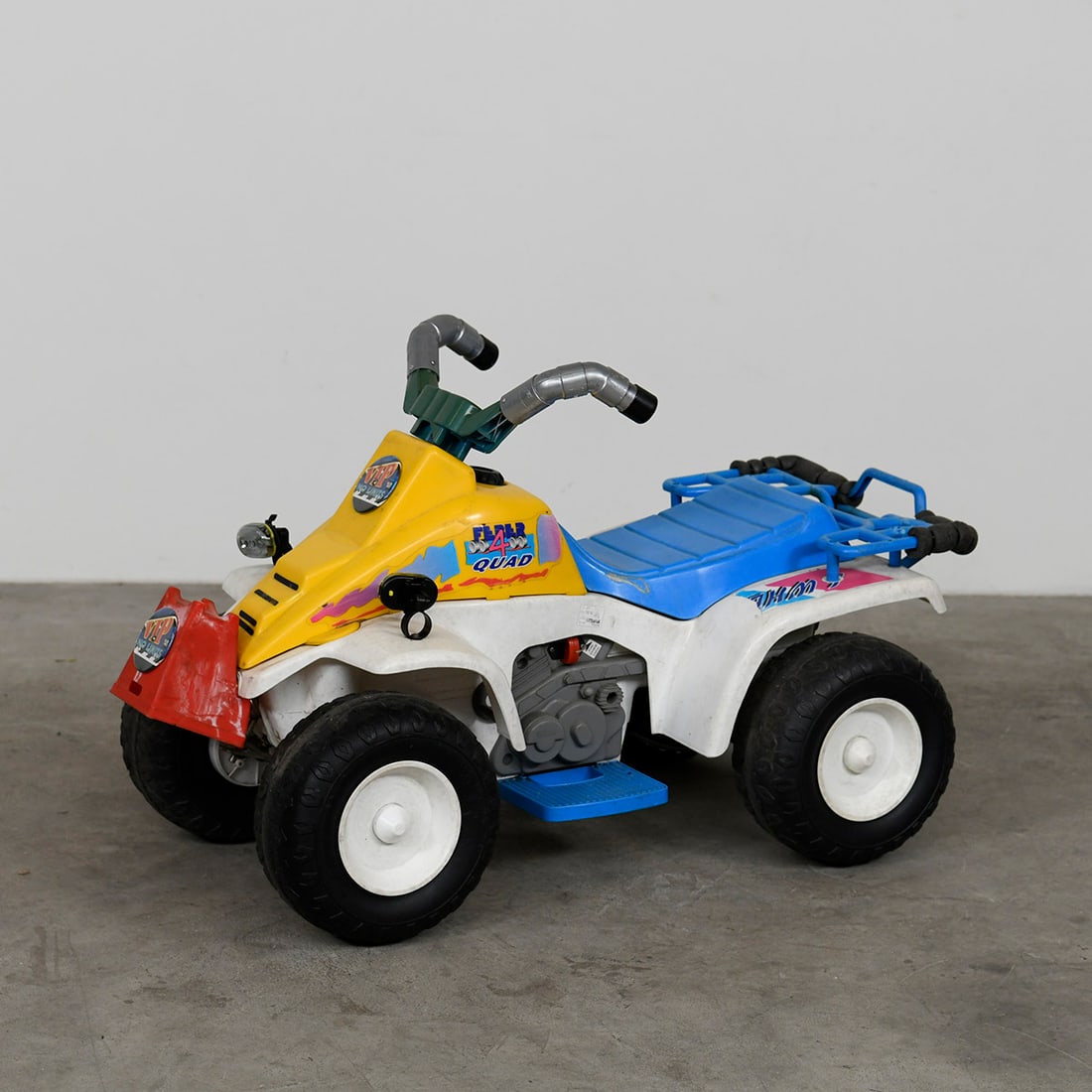 "VIP No Limits" 6-Volt Electric Children's Quad Bike in Blue, White, and Yellow Color Scheme: This "VIP No Limits" electric children's quad bike features a durable plastic body in a bright blue, white, and yellow color scheme. The quad is in a good working condition and has been updated with n