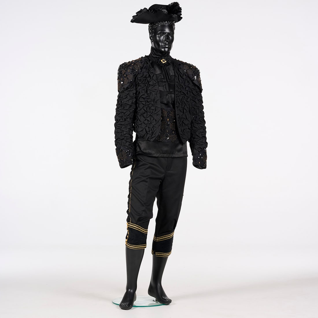 Original Costume Including a Hat Used by Royce to Perform the "Diakuba" Illusion: Original costume including a hat used by Royce to perform the "Diakuba" illusion. This theatrical black costume consists of a highly textured, cropped jacket, matching breeches, a ruffled shirt, and a