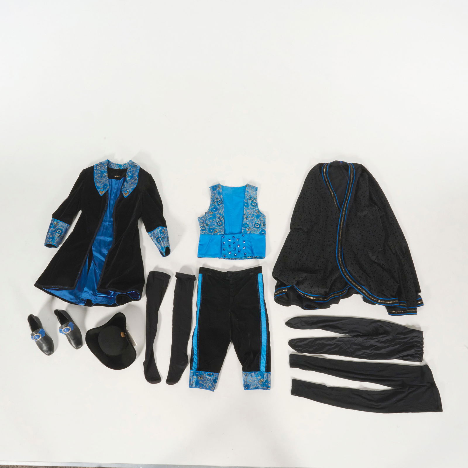 Original Costume Used by Royce Planned to Perform the "X-women" Illusion: Original costume used by Royce planned to perform the "X-women" illusion. This ornate 18th-century style theatrical costume is constructed primarily from black velvet accented with vibrant blue brocad