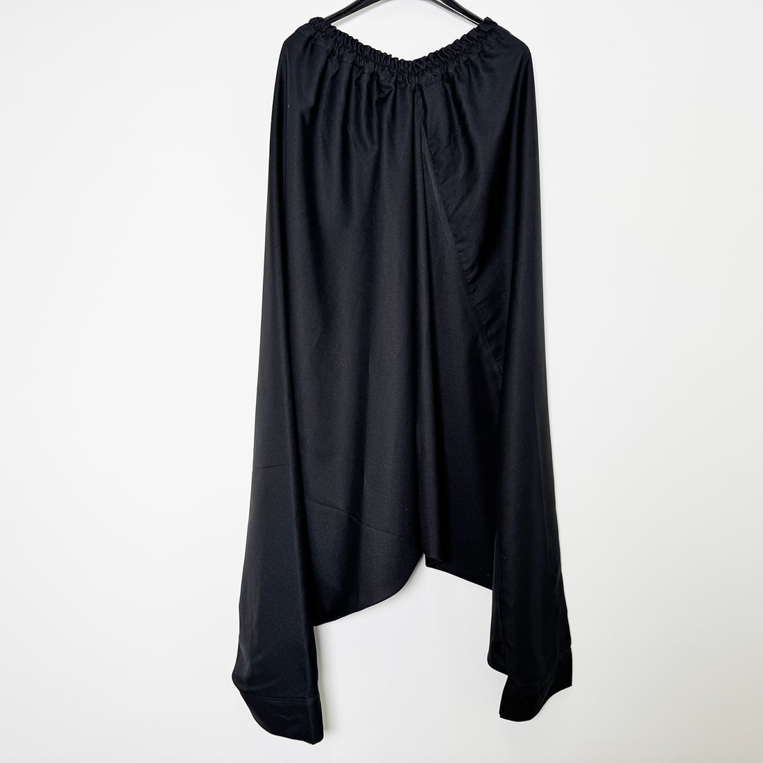 One of the Two Original Costumes Used by Royce to Perform the "De Koker" Illusion: One of the two original costumes used by Royce to perform the "De Koker" illusion. This theatrical ensemble consists of a knee-length, sleeveless tunic in dark blue fabric featuring an intricate flora