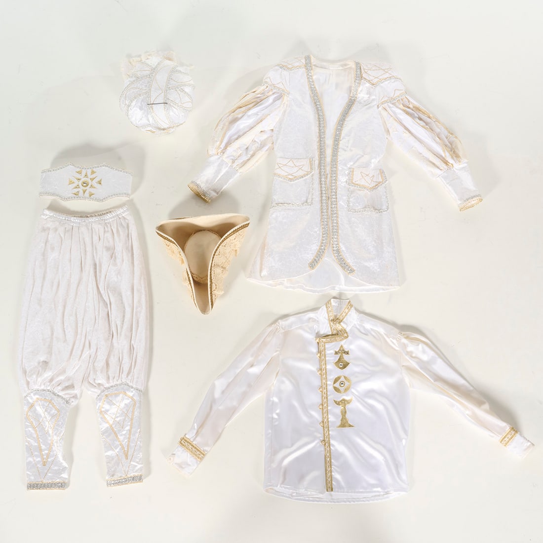 One of the Two Original Costumes Used by Royce to Perform the "Crown" Illusion: One of the two original costumes used by Royce to perform the "Crown" illusion. This ornate white costume consists of several pieces all heavily embellished with silver and gold color metallic trim. T