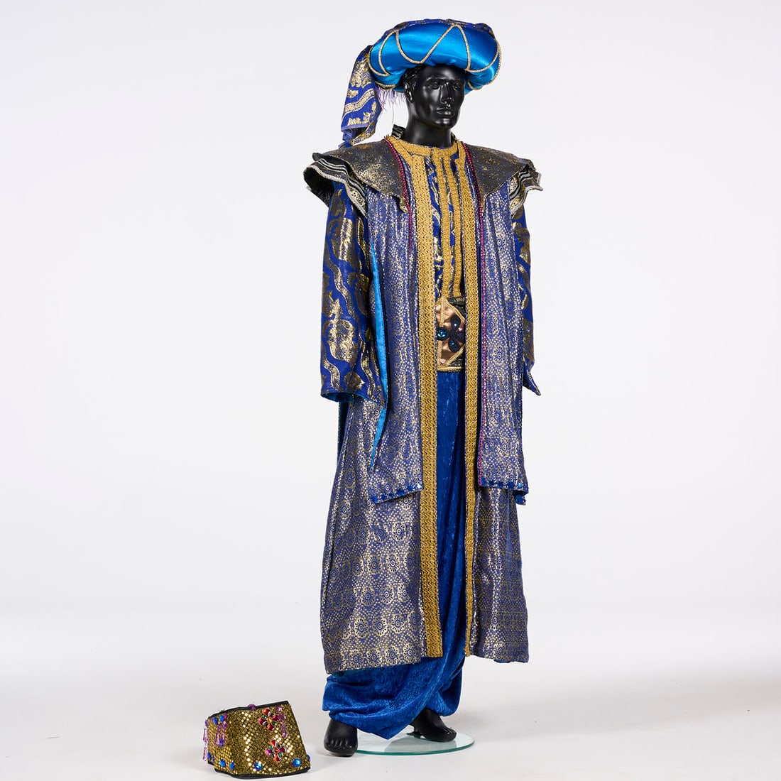 One of the Two Original Costumes Used by Royce to Perform the "Crown" Illusion: One of the two original costumes used by Royce to perform the "Crown" illusion. This royal blue and gold costume is a multi-piece ensemble featuring a long, open-front robe decorated with intricate go