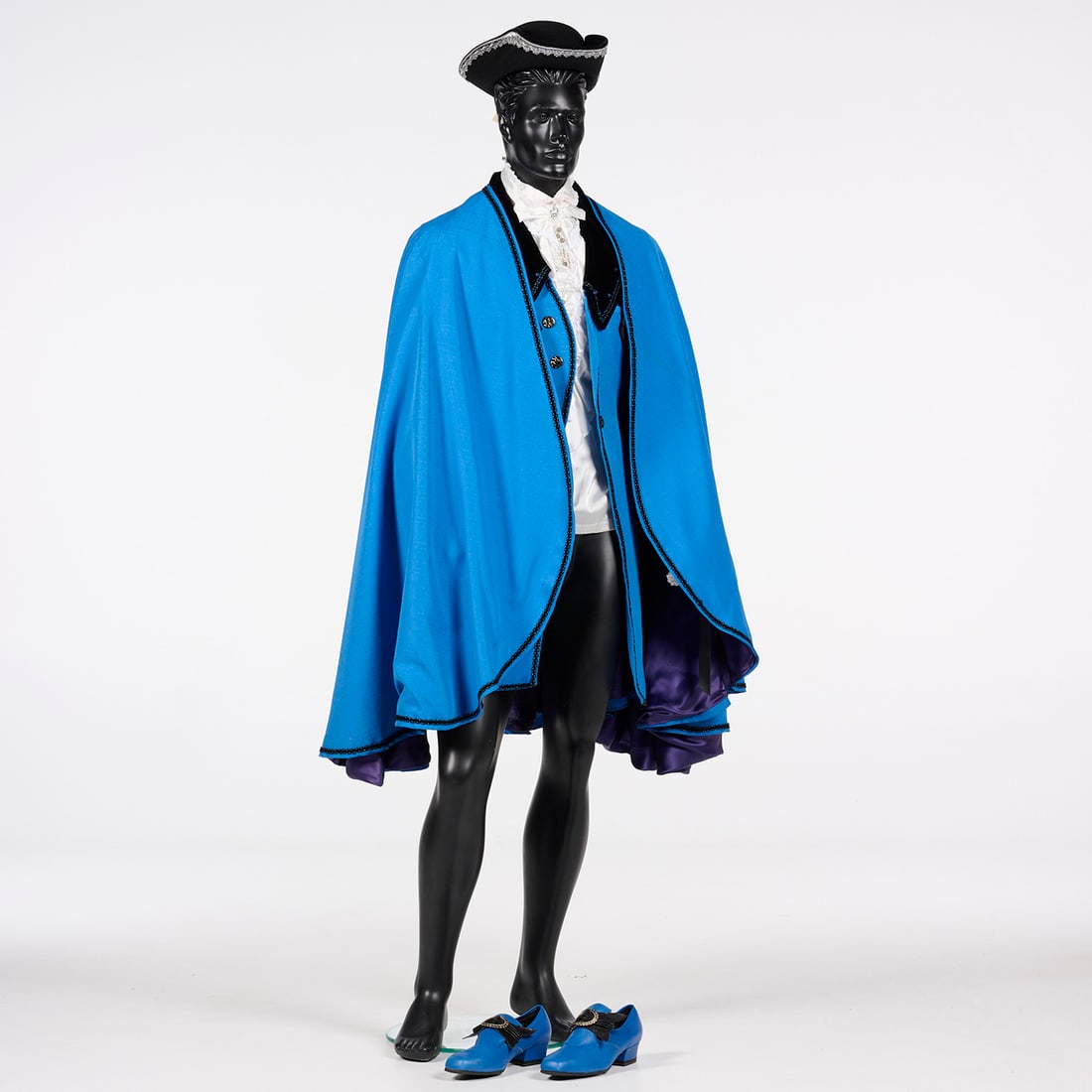 Original Costume Used by Royce to Present "The Globe": Original costume used by Royce to present "The Globe". This costume features a vibrant cerulean blue cape with a purple satin lining and black braided trim accented by metallic blue thread. Worn under