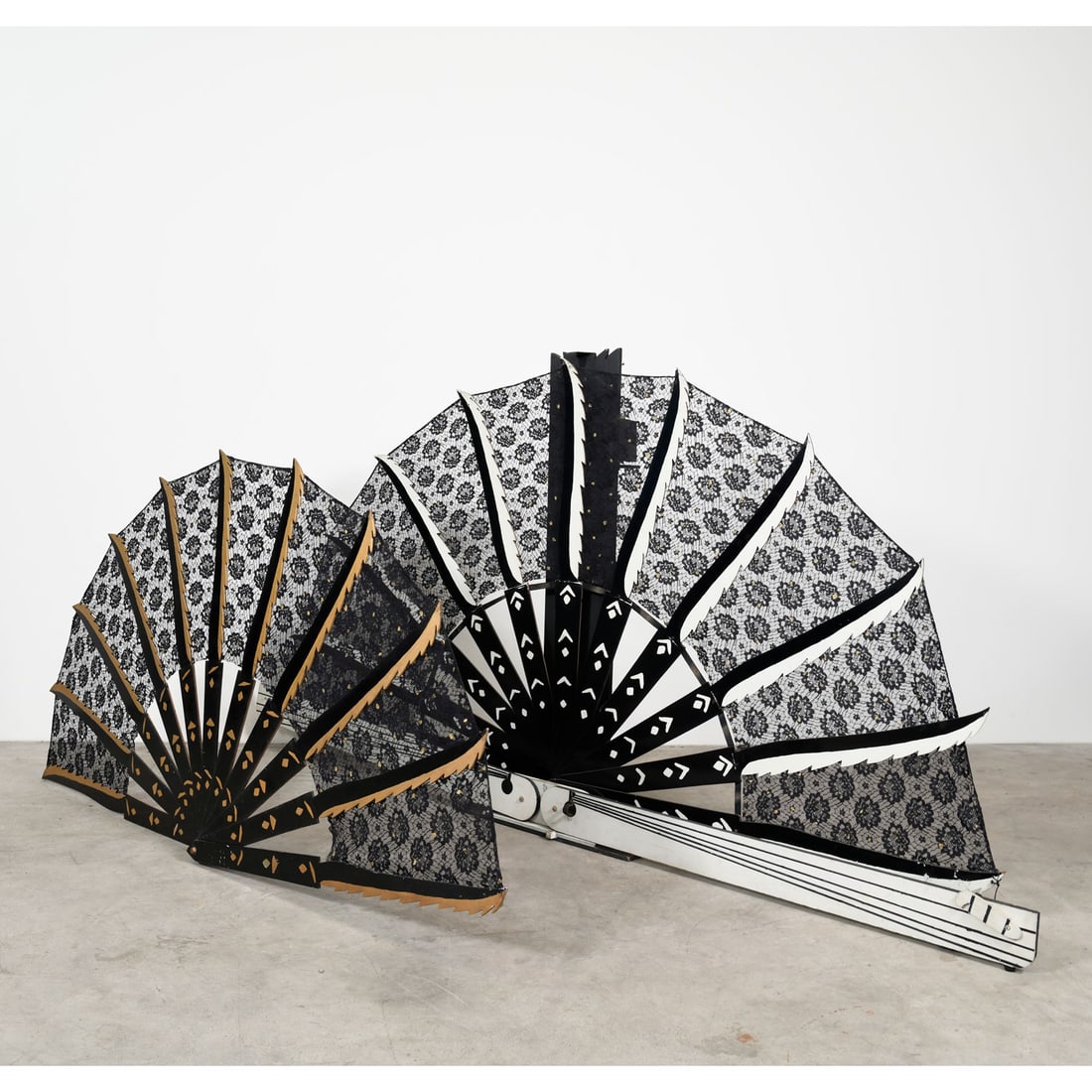 A set of Large and Small Unfolding Fan Magic Props Used by Royce in 1974: A set of large and small unfolding fan magic props used by Royce in 1974. Made from wood and black lace. Very good visual condition, showing some wear. Dimensions shown for the largest fan unfolded. F