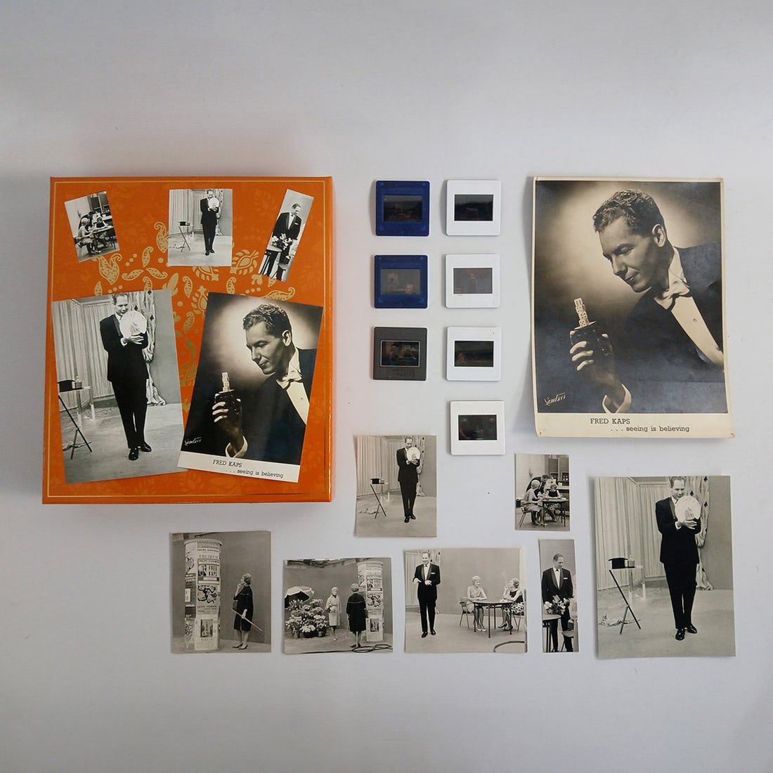 Royce Owned Box with Magician Fred Kaps Postcards, Photo Prints and 35 mm Photographic Slides: Royce owned box with magician Fred Kaps postcards, photo prints and 35 mm photographic slides. Overall very good visual condition showing some wear and aging. Dimensions (H x W x D): 6 x 24 x 28 cm. C