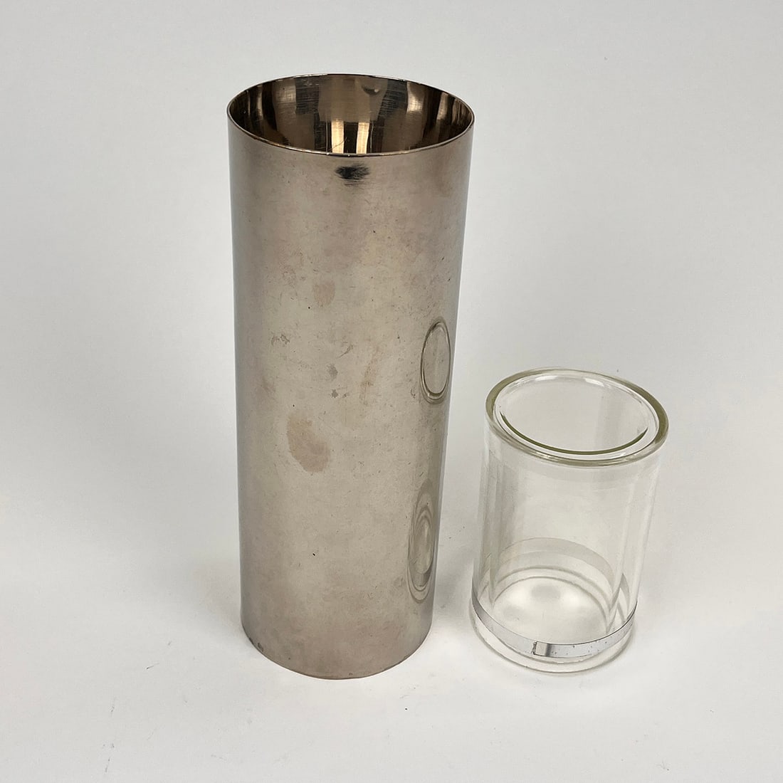 Cylinder and Glass Magic Trick: Magic trick with large cylinder and glass. A glass is filed with milk covered by a chrome tube. Milk and glass magically disappear. The glass is real glass. In good condition. Dimensions (H x W x D):