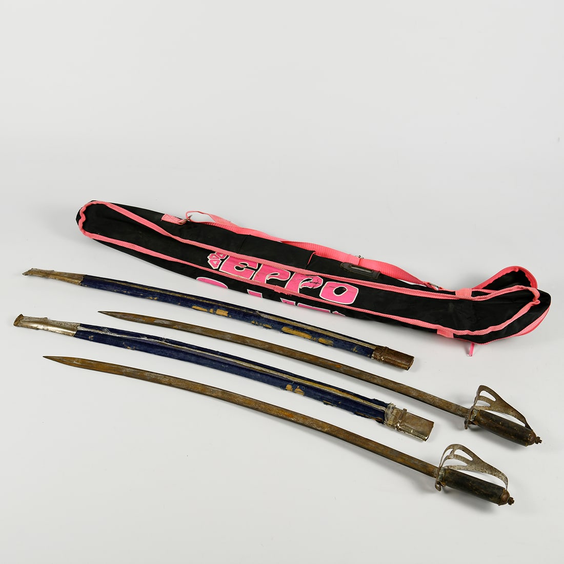 Set of 2 Vintage Prop Swords with Bag for Transport: This set includes two vintage prop swords accompanied by a transport bag. Both swords are in unrestored visual condition with significant surface rust, and the decorative elements on the sheaths show