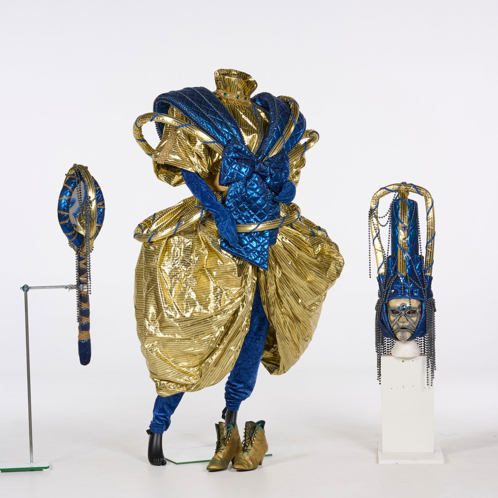 Original "Artura" Walking Act Costume from the Royce Collection: Original "Artura" walking act costume from the Royce Collection. This elaborate theatrical costume is a striking display of avant-garde craftsmanship, featuring a metallic gold and deep blue palette.