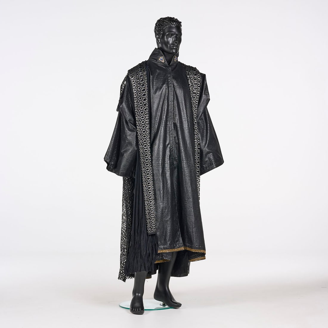 Original Black Costume with a Cape Stage Used by Royce: Original black costume with a cape stage used by Royce. This floor-length black costume features a high, stand-up collar adorned with blue and gold gemstone embellishments and a robe constructed from