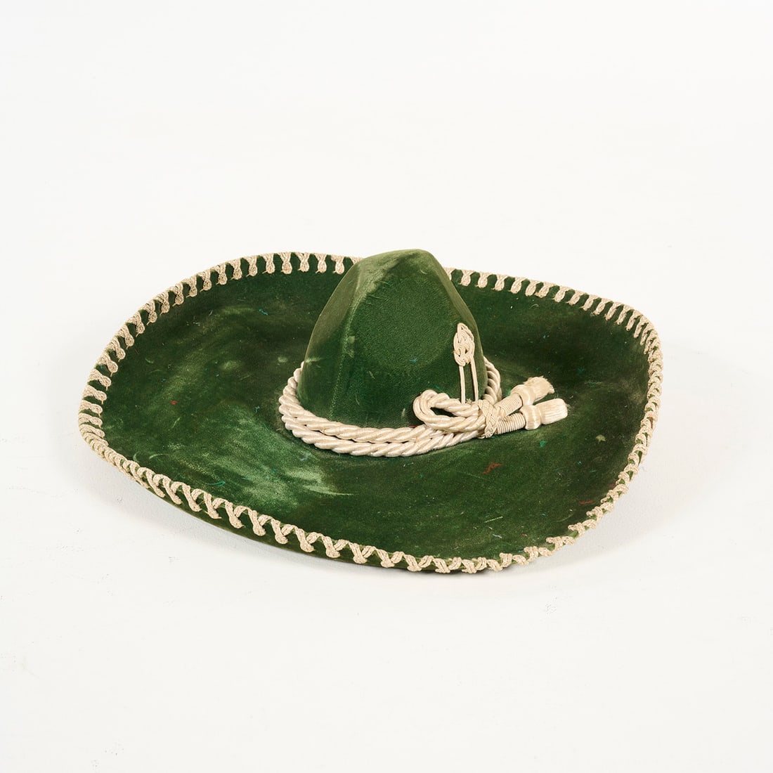Vintage Green Velvet Mexican-style Sombrero from the Royce Collection: Vintage green velvet Mexican-style sombrero from the Royce Collection. A thick, cream-colored decorative rope circles the base of the crown, while the brim’s edge is finished with an intricate braid