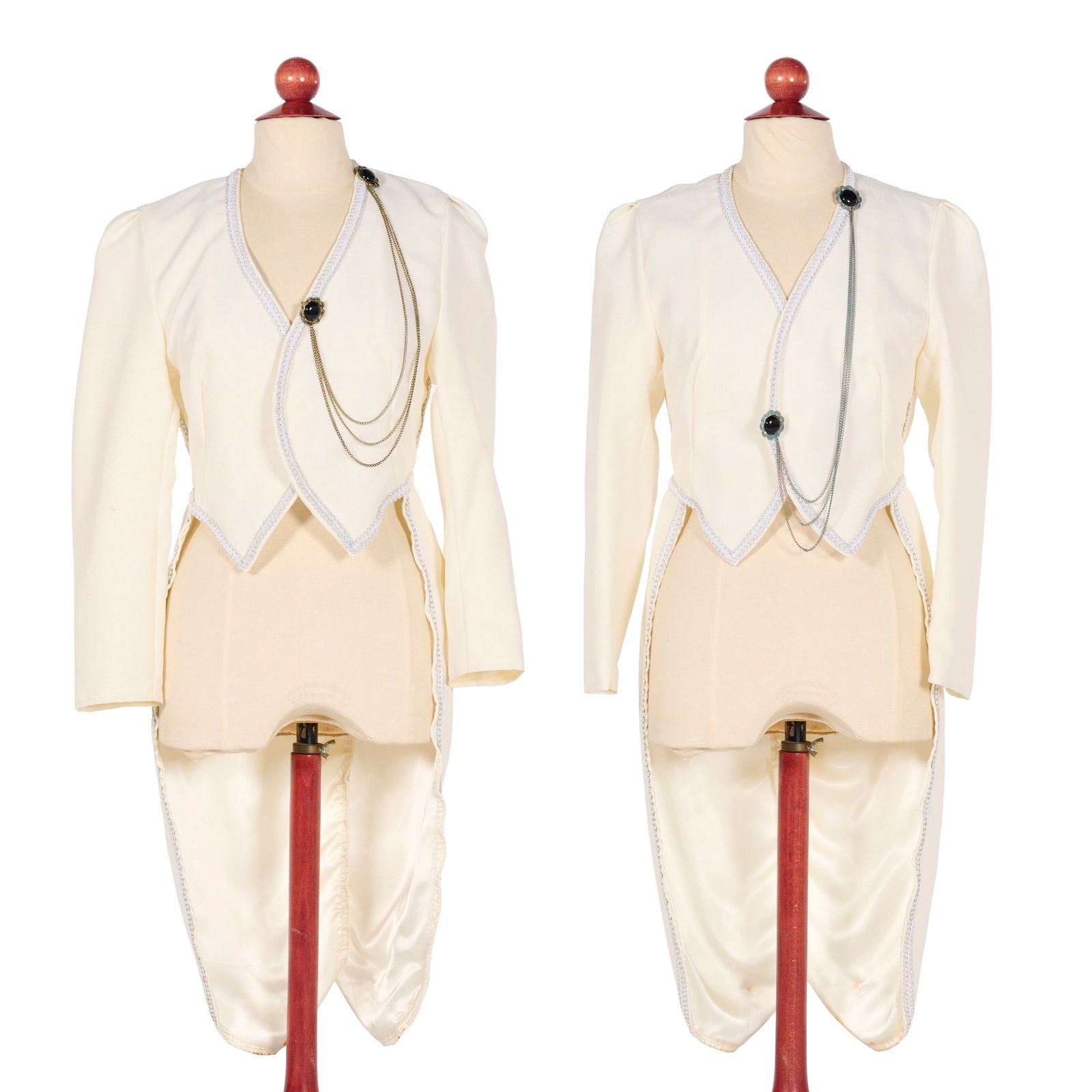 Set of 2 Original Cream-colored Tailcoats from the Royce Collection: This pair of original cream-colored theatrical tailcoats from the Royce Collection features a cropped, open-front bodice and long sleeves. Each garment is embellished with silver braided trim and furt