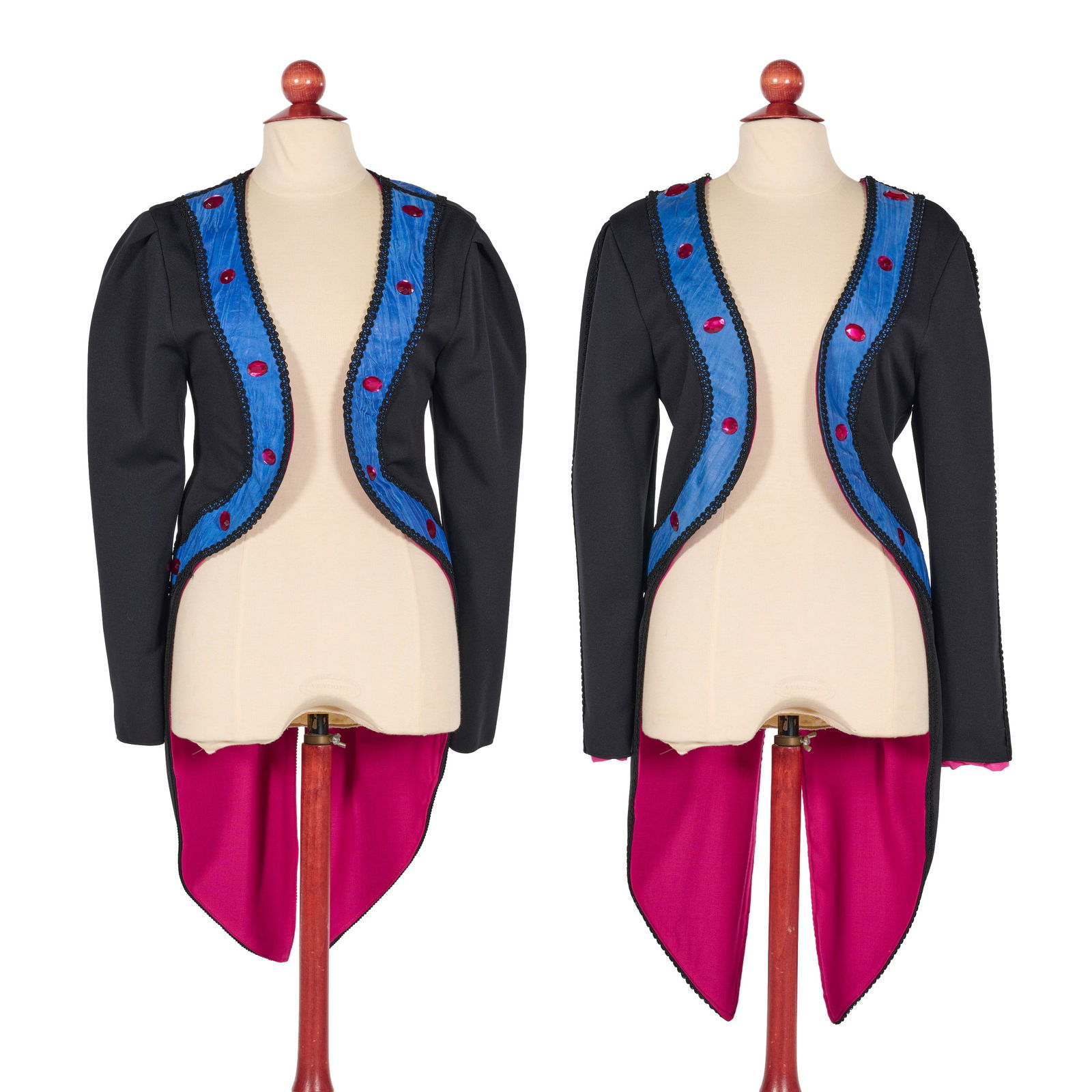 Set of 2 Original Black Tailcoats from the Royce Collection: Set of two original theatrical black tailcoats from the Royce Collection. They are accented with bright blue panels and a vibrant magenta lining. The coats are designed with a cropped front and long,
